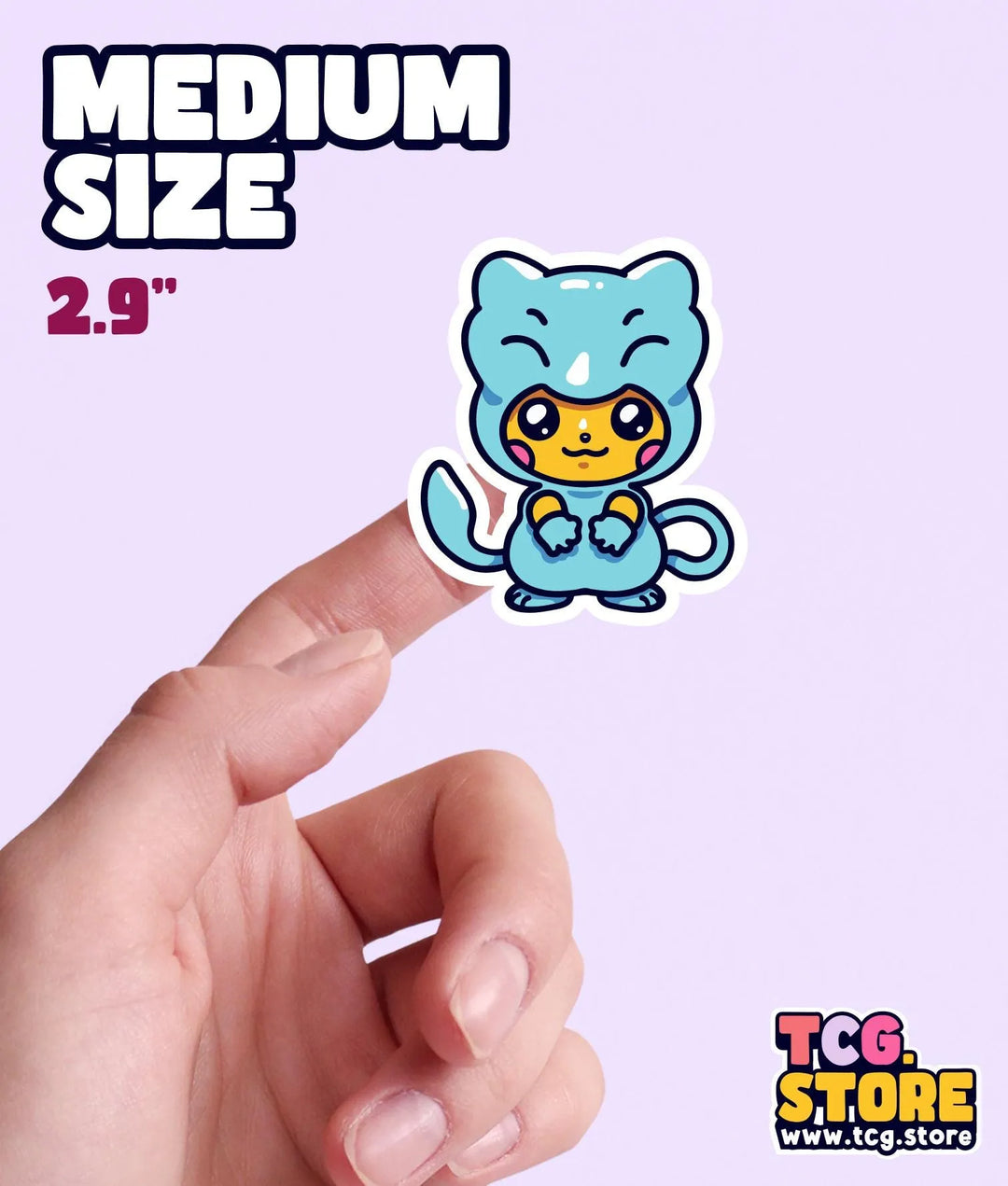 a hand holding a small sticker of a blue cat