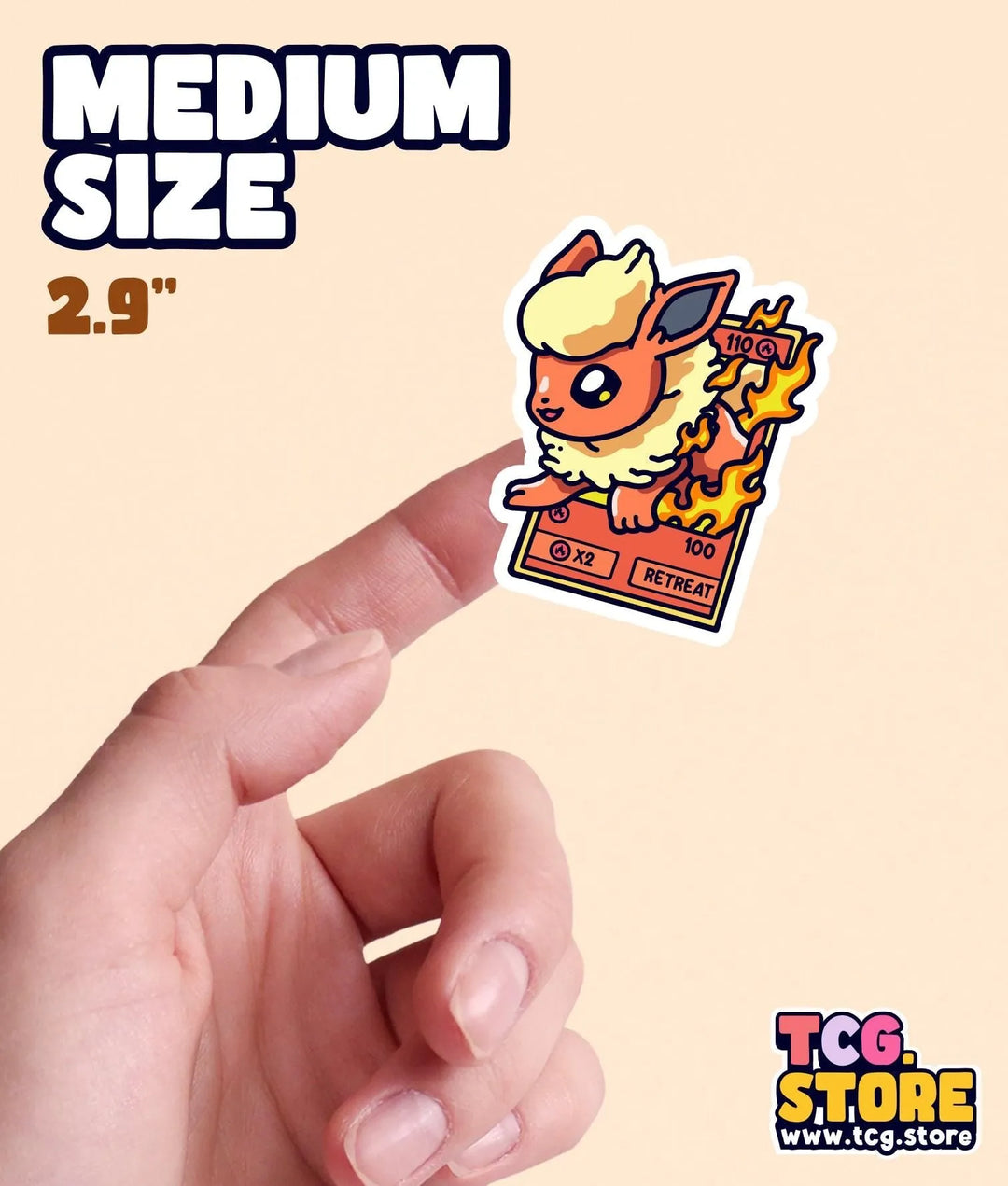 a hand holding a small sticker of a cartoon character