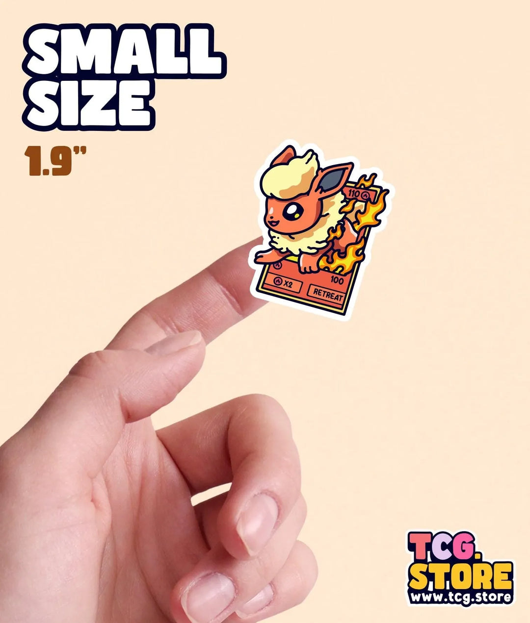 a hand holding a small sticker in front of a white background