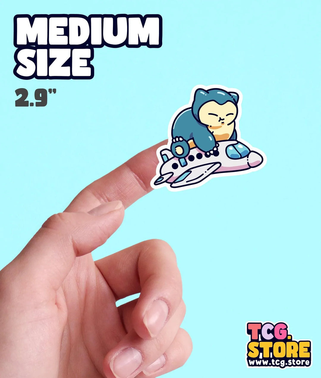 a hand holding a small sticker of a cartoon character