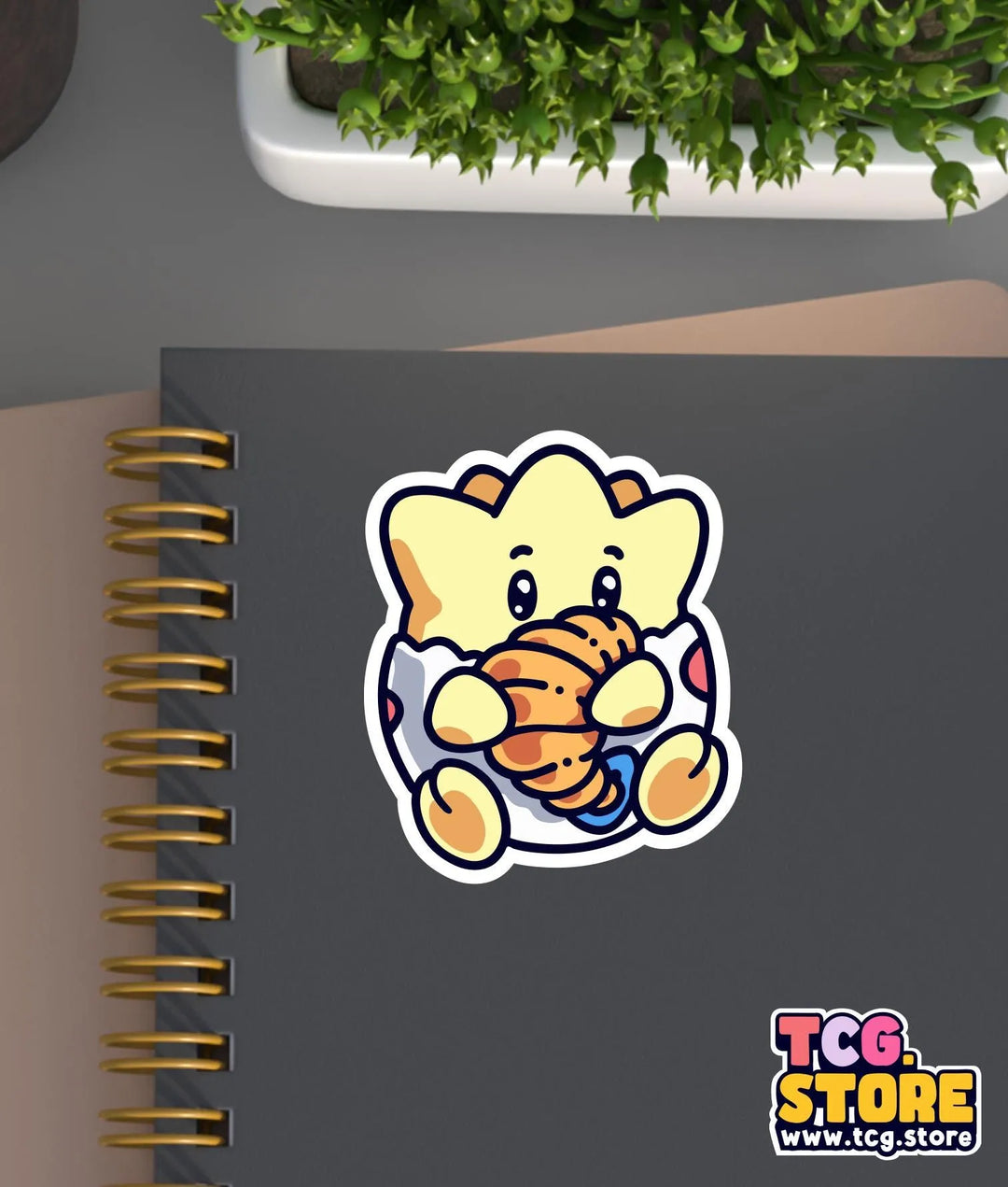 a notebook with a sticker of an elephant holding a teddy bear