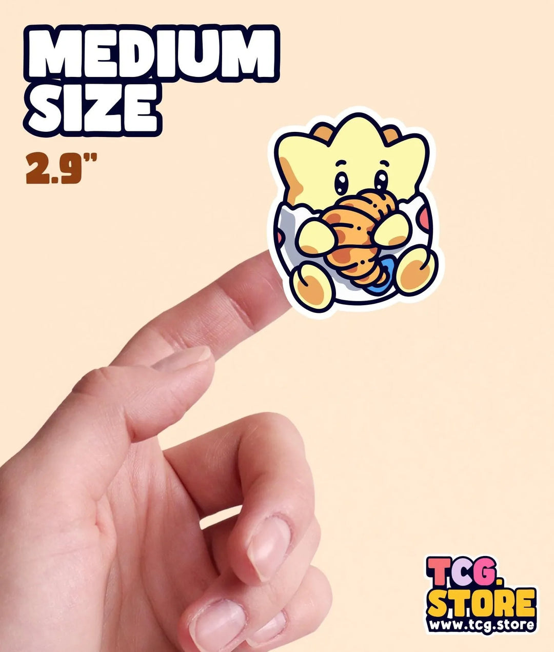 a hand holding a small sticker of a teddy bear