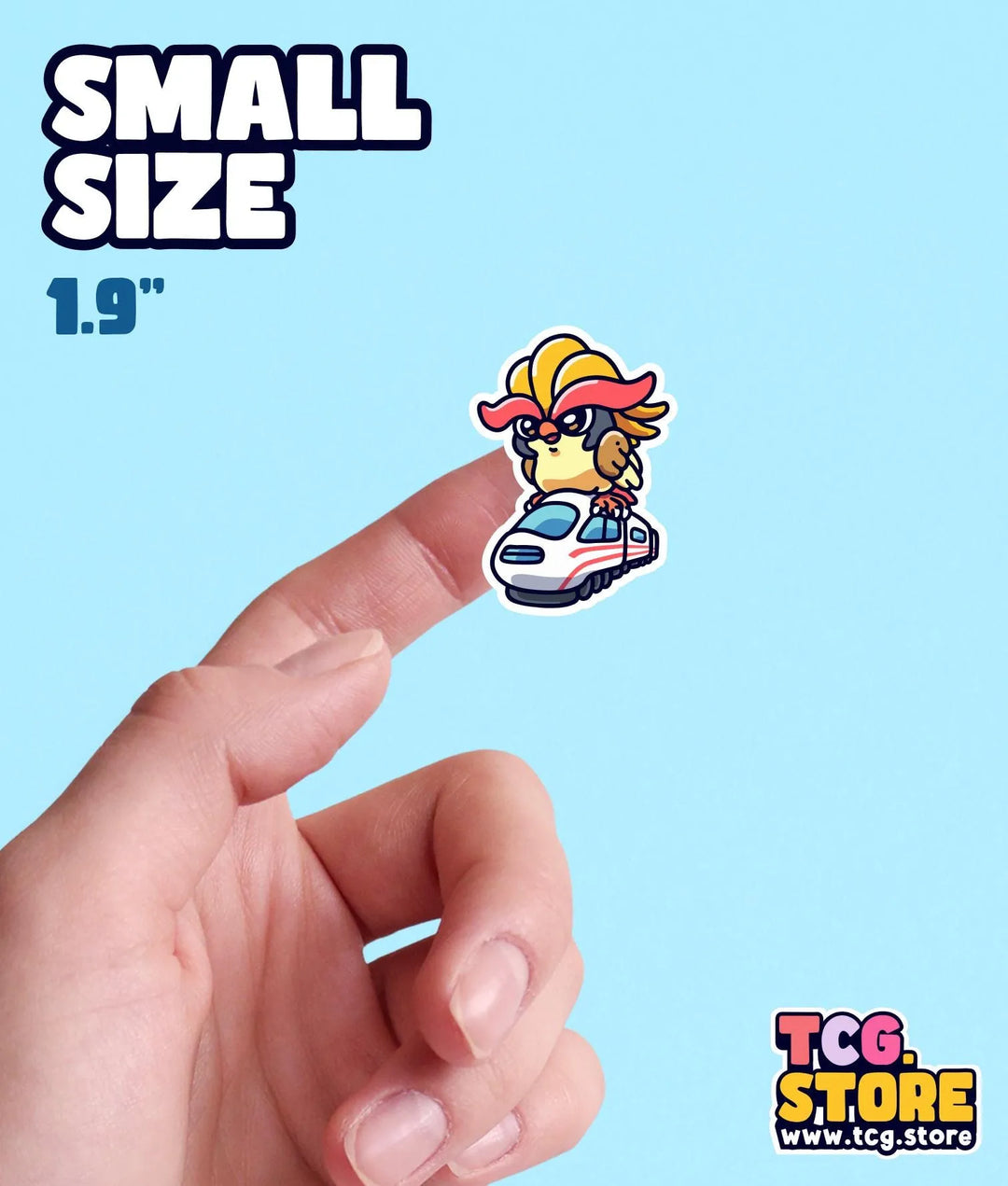 a hand holding a small sticker of a cartoon character