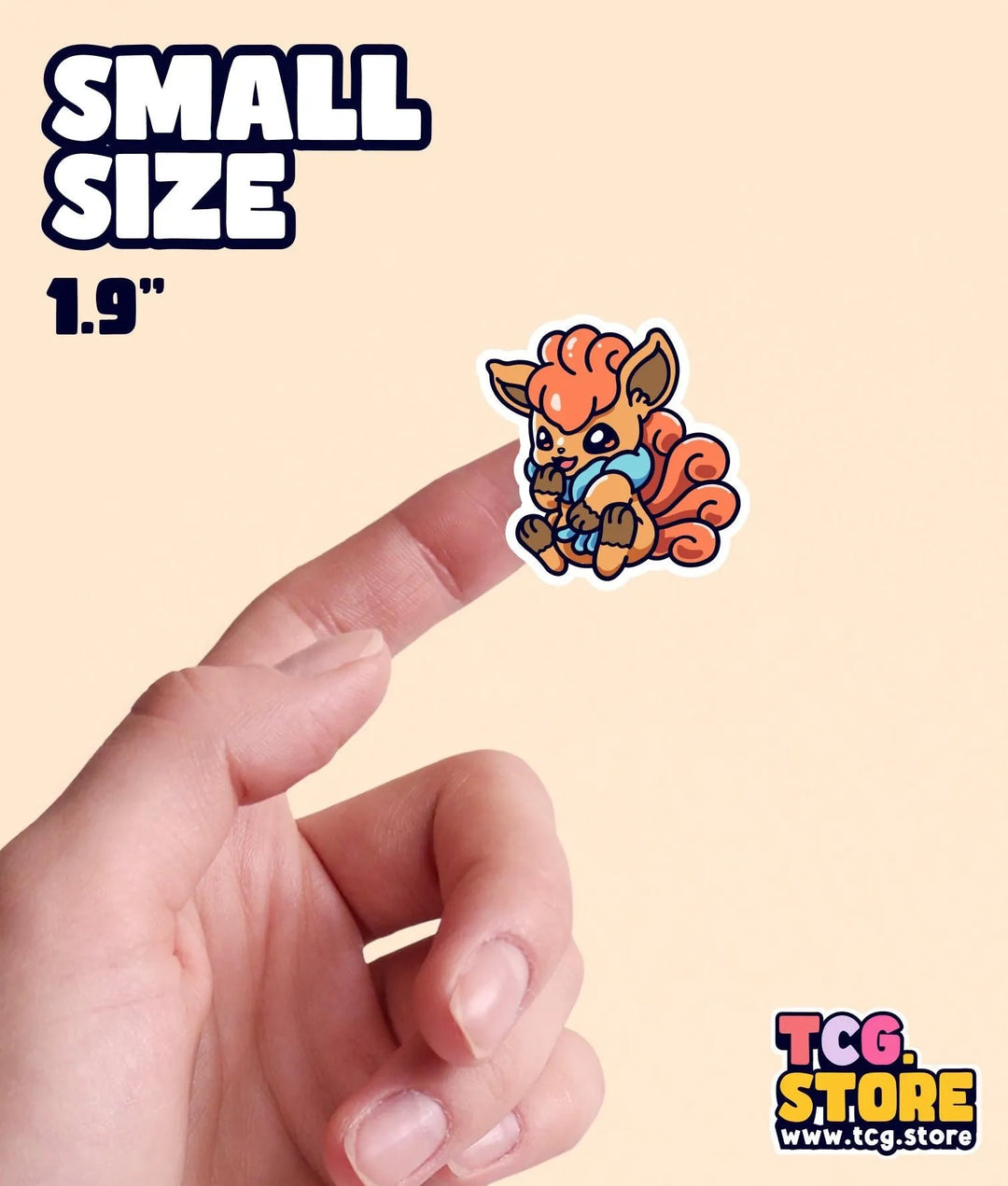 a hand holding a small sticker of a cartoon character