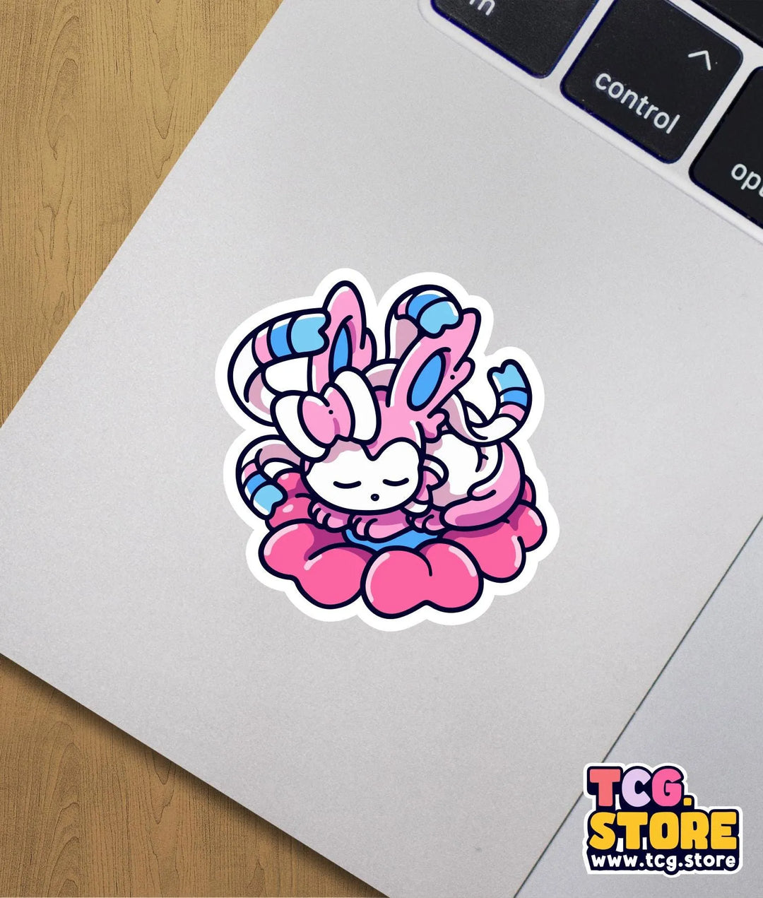 a sticker of a pink and blue crab on a laptop