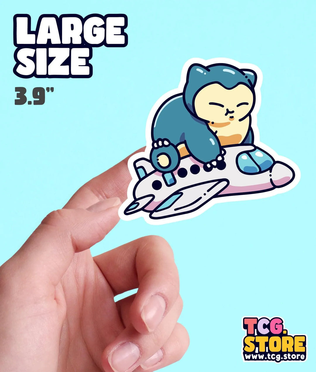 a hand holding a sticker of a cat on a plane