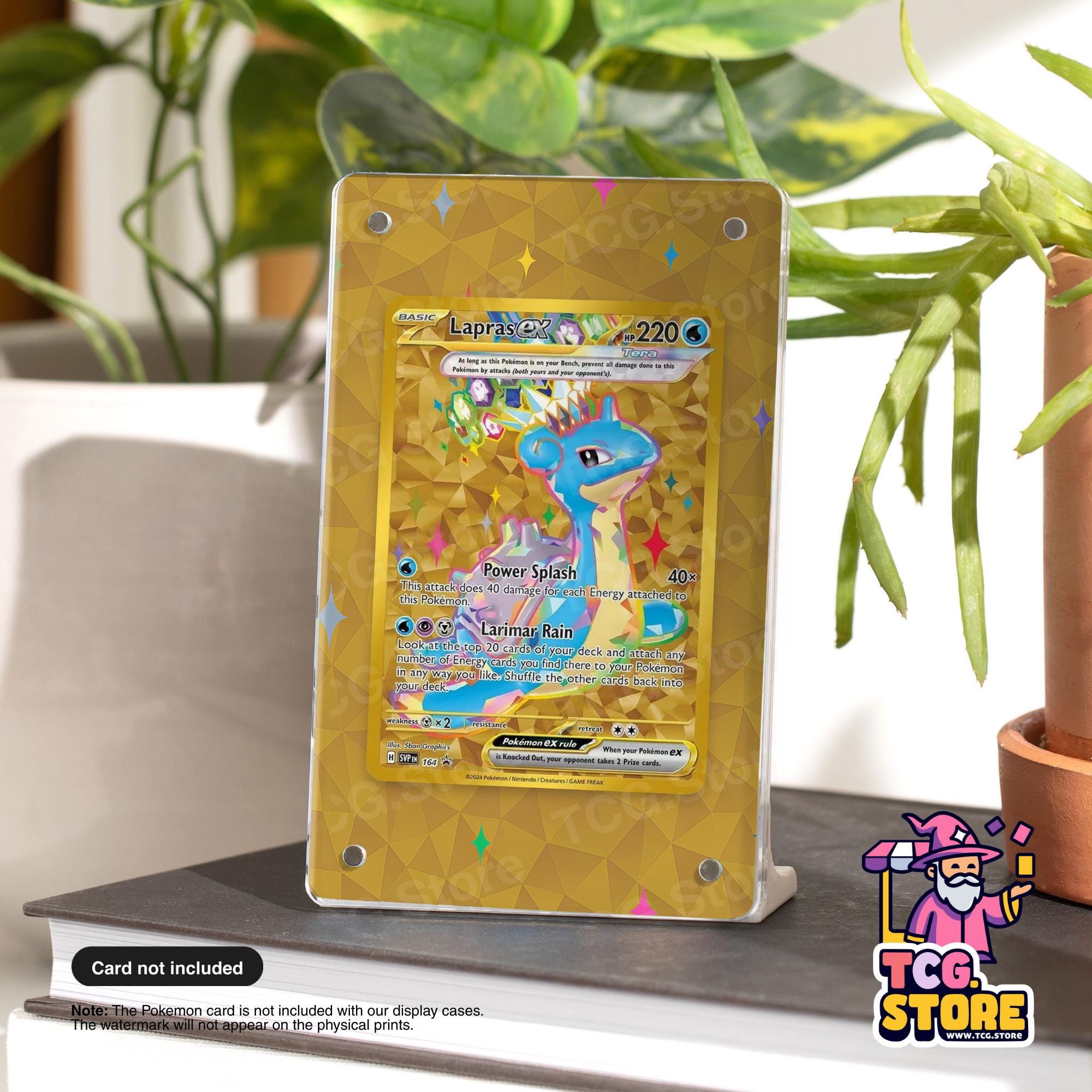 A Pokémon card display case with a Pokémon card on it, placed on a table next to a potted plant.