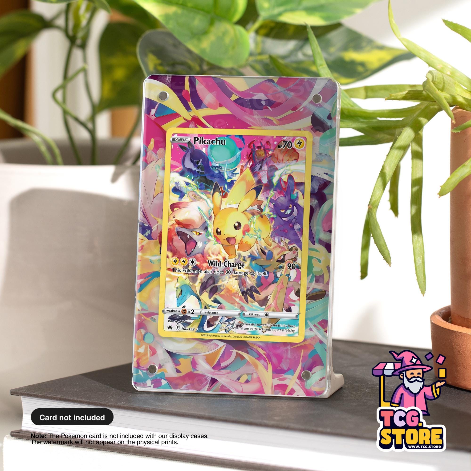 A Pokémon card featuring Pikachu is displayed on a stand, with a plant in the background.