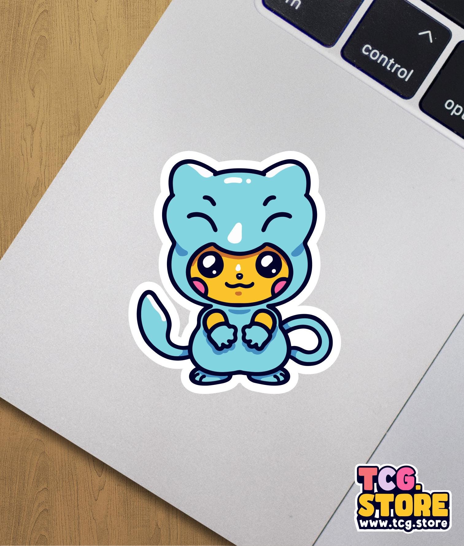 a sticker of a cat sitting on top of a laptop