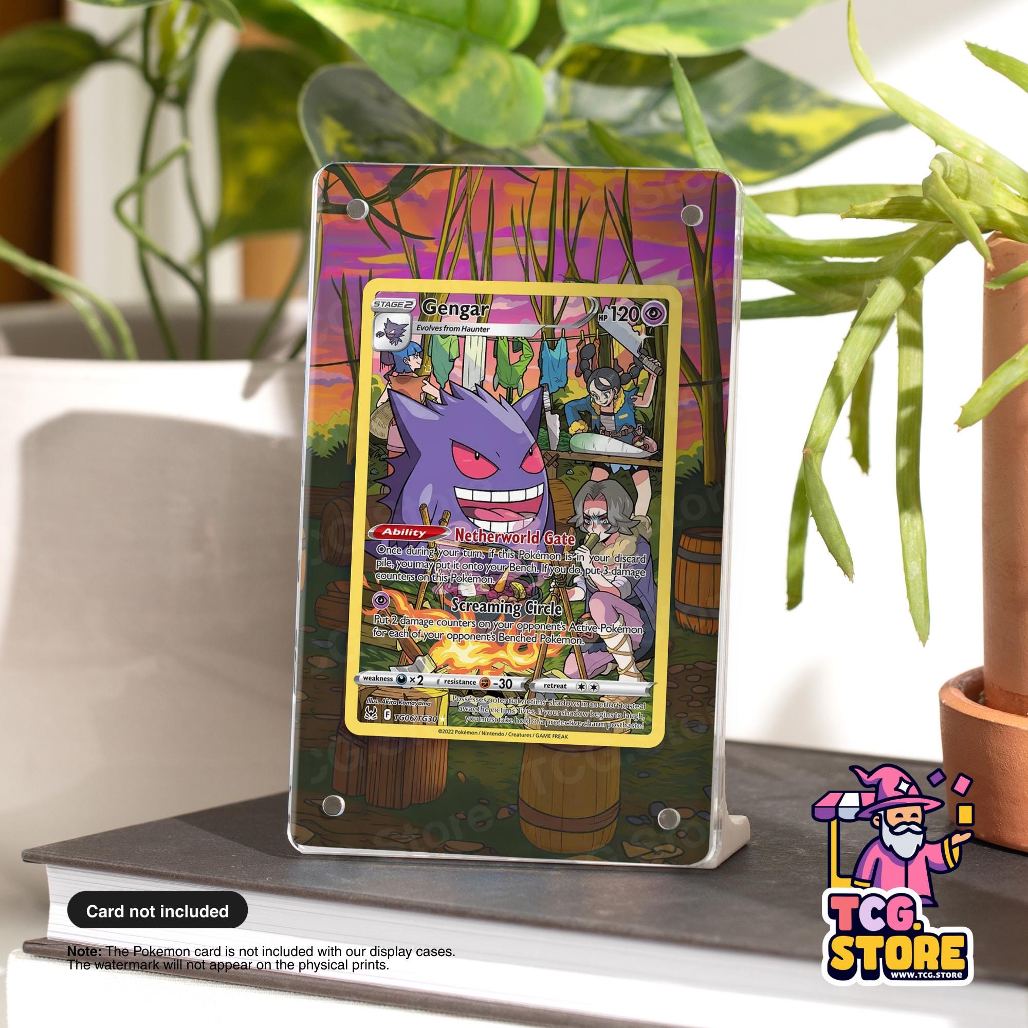 a Pokémon trading card displayed on a stand, with a plant in the background.