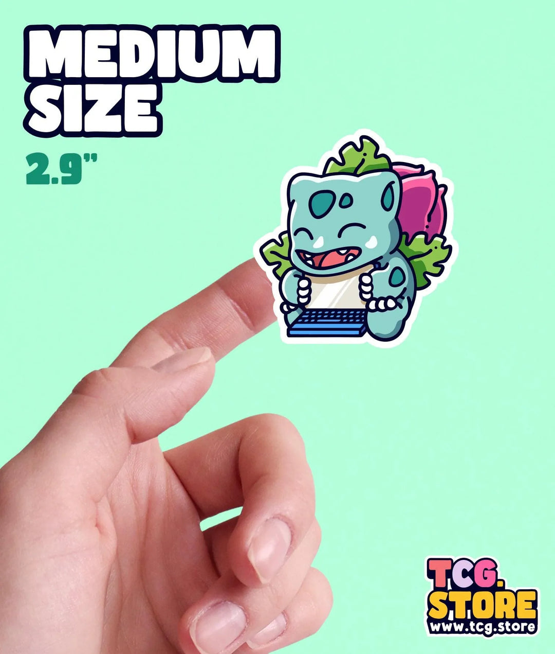 a hand holding a small sticker of a cartoon character