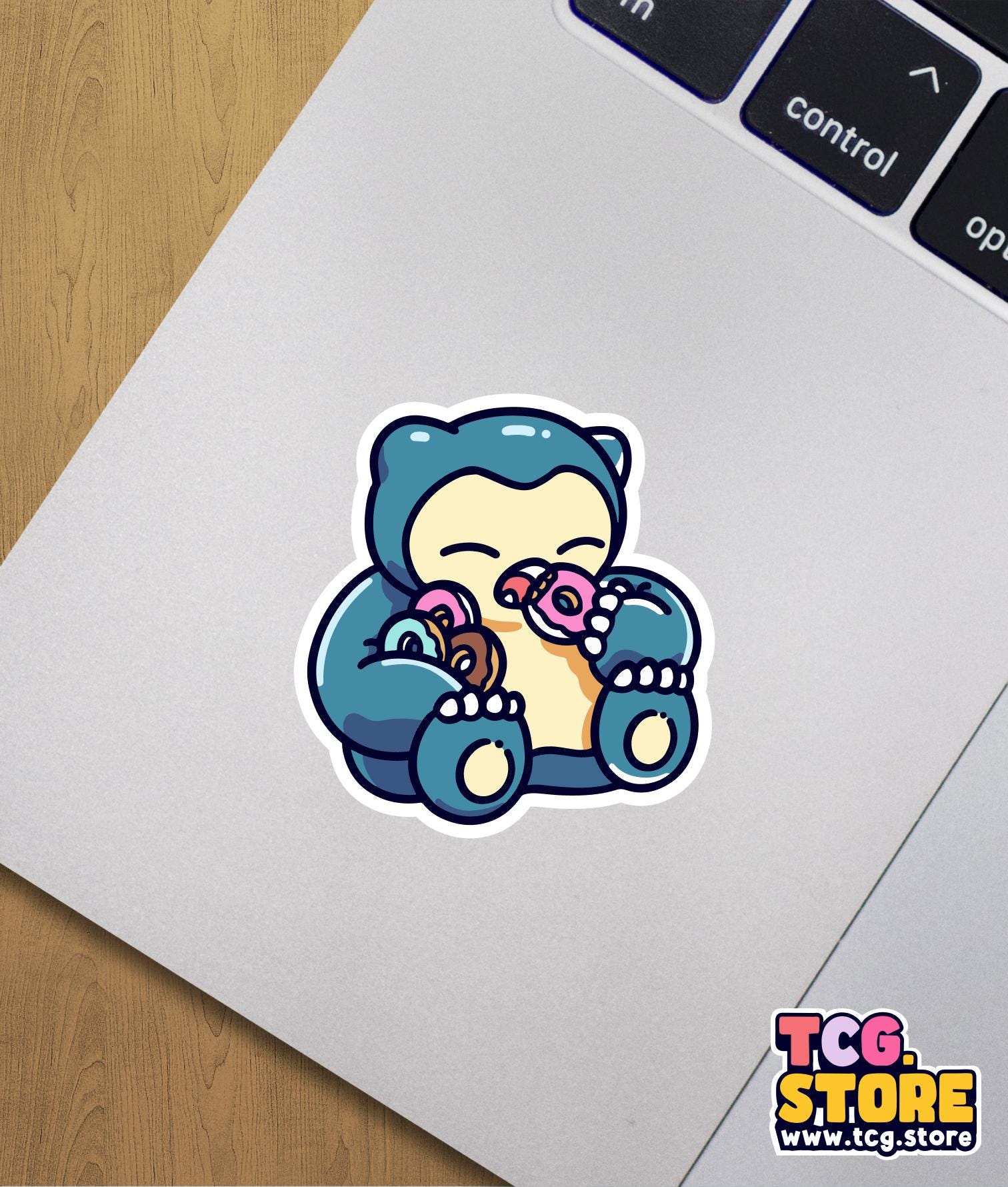 a sticker of a blue teddy bear with a donut in its mouth