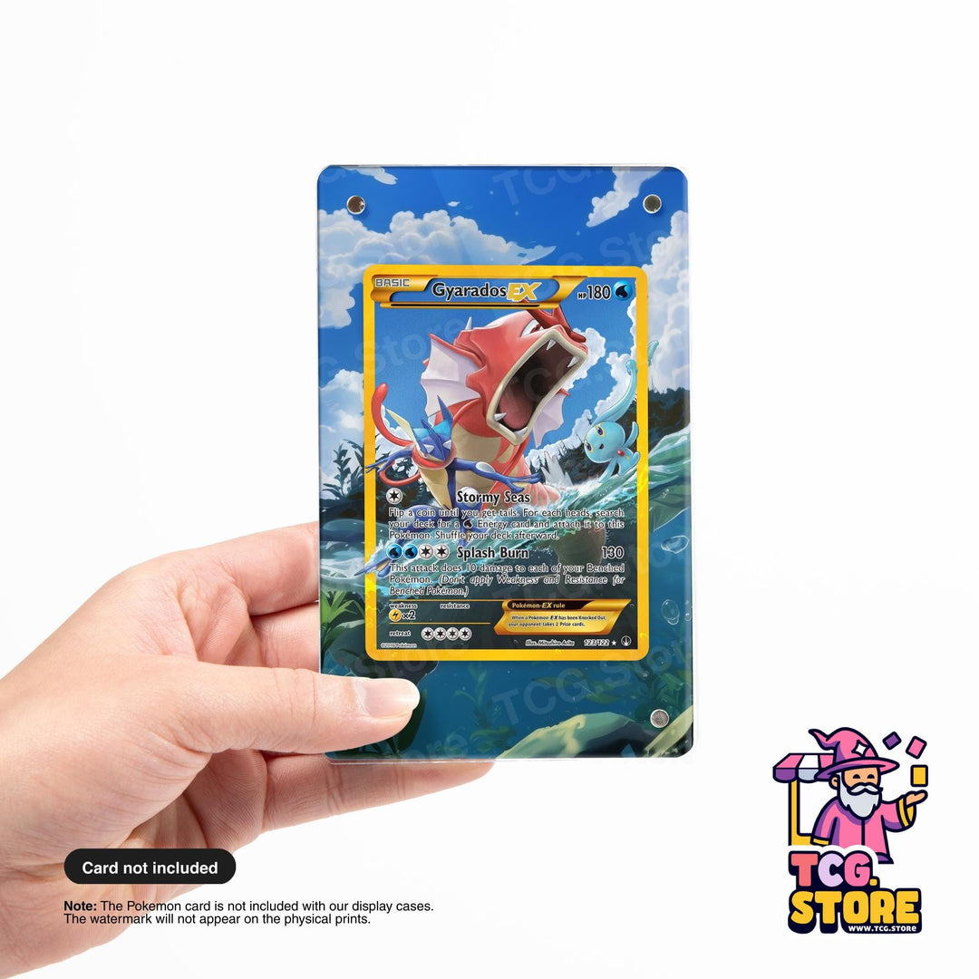A person's hand holding a Pokémon trading card featuring a red and white Pokémon creature against a blue and green background.