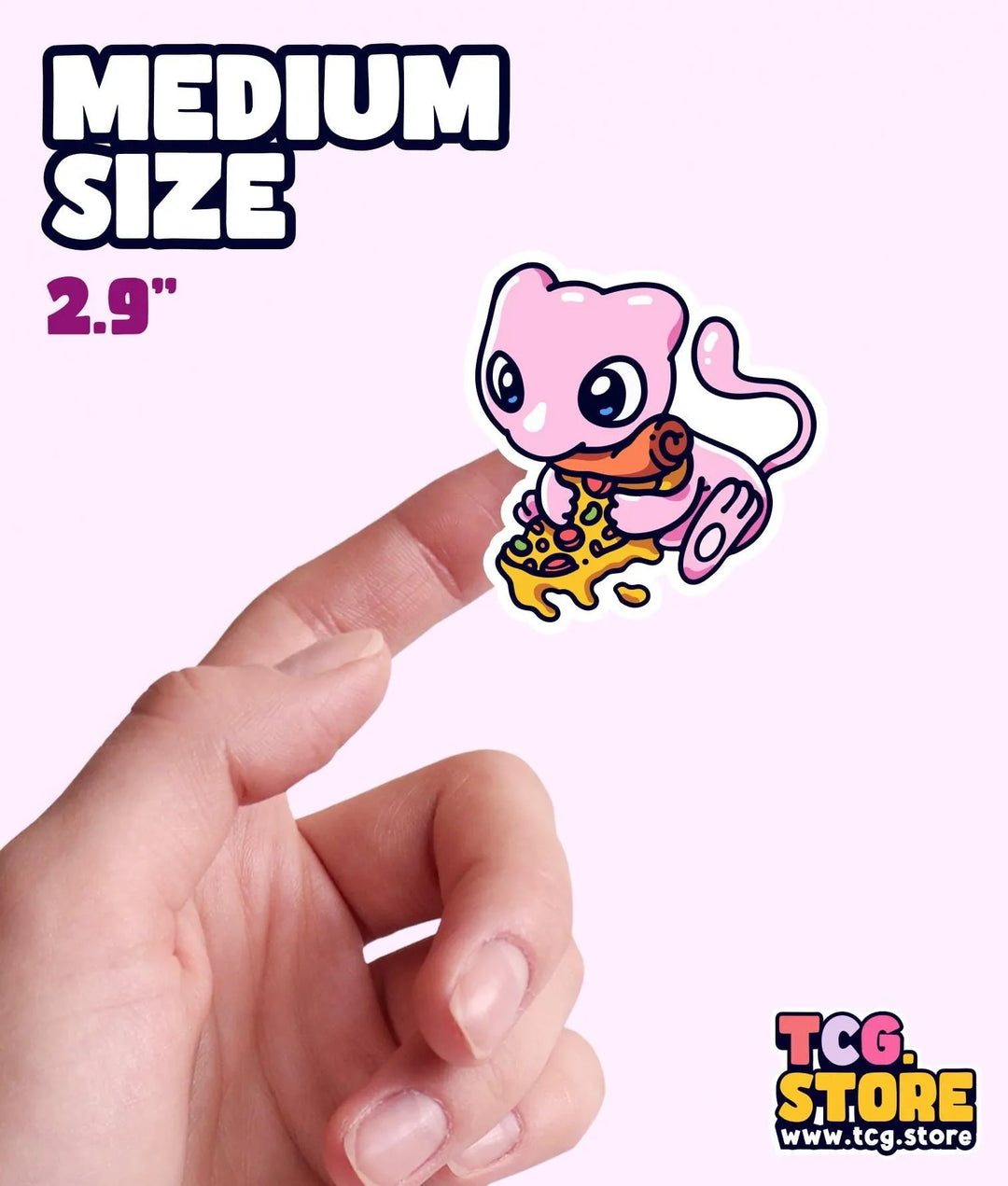 a hand holding a small sticker of a cartoon character