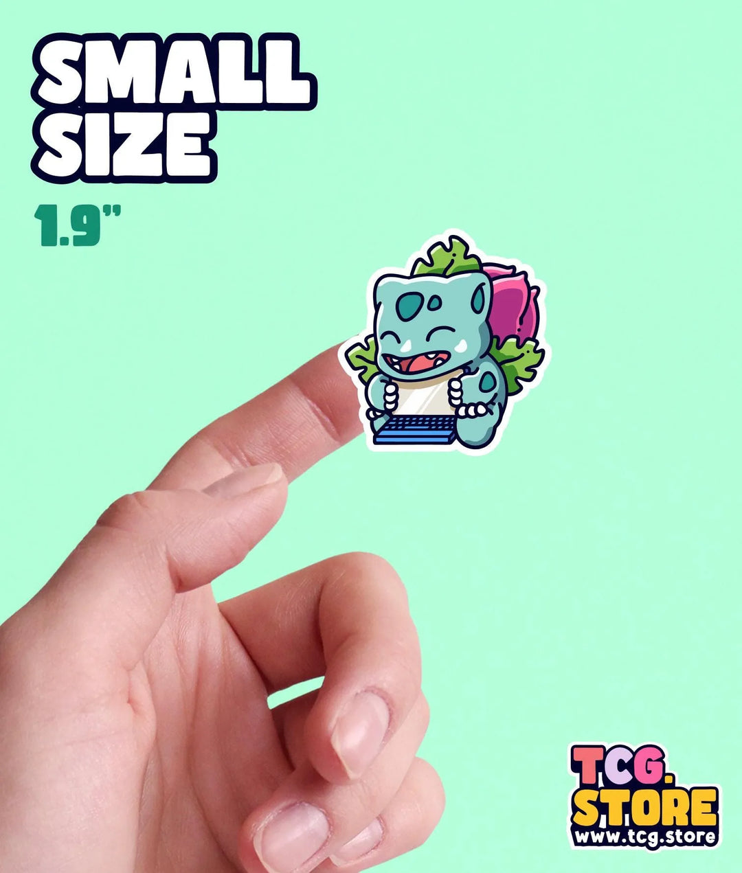 a hand holding a small sticker of a cartoon character
